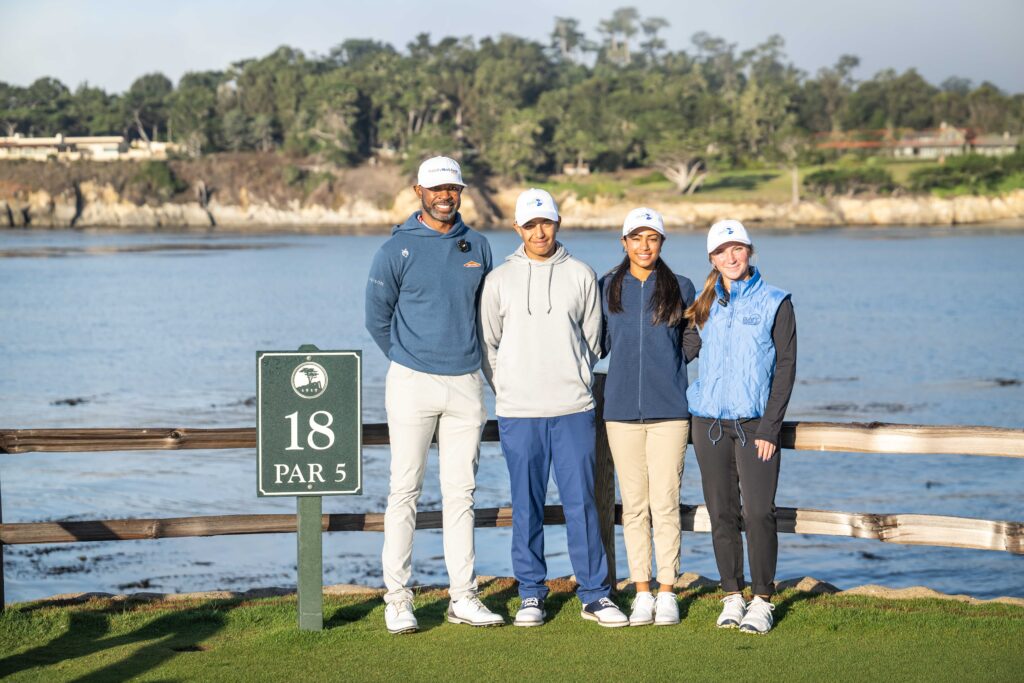 4 golfers posing for photo on hole 18
